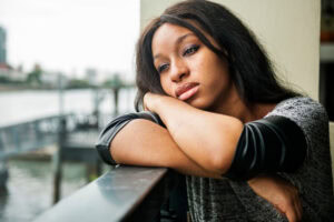 Young black woman experiencing the common signs and symptoms of ptsd