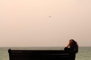 Woman sitting and wondering is self harm an addiction